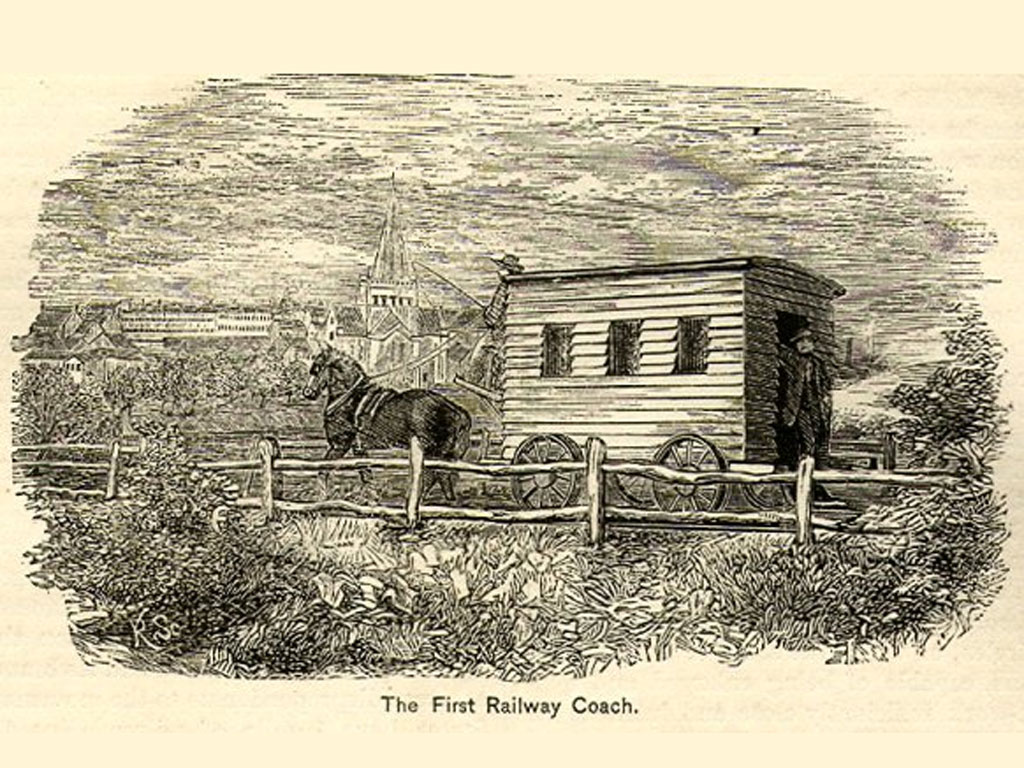 Line drawing of a horse-drawn railway captioned 'the first railway coach'