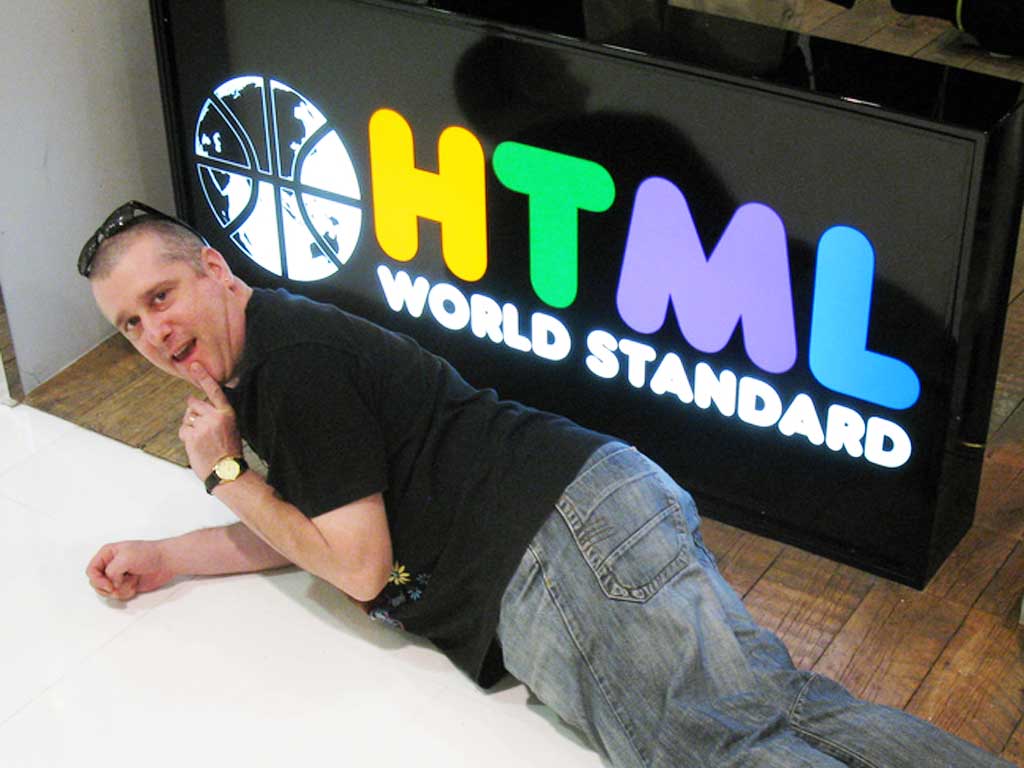 bruce in front of 'HTML' sign